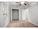 Bedroom with neutral carpeting and walls, a ceiling fan, and a closet for ample storage at 1512 Maybrook Dr, Raleigh, NC 27610
