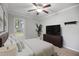 Cozy bedroom featuring a ceiling fan, plush carpet, and neutral paint colors at 1512 Maybrook Dr, Raleigh, NC 27610