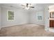 Bright, spacious bedroom featuring neutral carpeting, and an ensuite bathroom for added convenience at 1512 Maybrook Dr, Raleigh, NC 27610