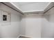 A walk-in closet featuring integrated shelving and a digital keypad safe for secure storage at 1512 Maybrook Dr, Raleigh, NC 27610