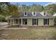 Charming exterior elevation with dormer windows and a cozy covered porch, offering great curb appeal at 1512 Maybrook Dr, Raleigh, NC 27610