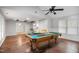 Spacious recreational room with a pool table, beamed ceiling, and abundant natural light at 1512 Maybrook Dr, Raleigh, NC 27610