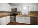 Updated kitchen features granite countertops, stainless steel appliances, and white cabinetry at 1512 Maybrook Dr, Raleigh, NC 27610