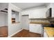 Cozy kitchen features granite countertops, white cabinets, and stainless steel appliances at 1512 Maybrook Dr, Raleigh, NC 27610