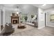Bright living room featuring a fireplace, hardwood floors, and ample seating space at 1512 Maybrook Dr, Raleigh, NC 27610