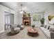 Comfortable living room with a fireplace, large window, and stylish furniture at 1512 Maybrook Dr, Raleigh, NC 27610