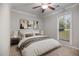 Inviting main bedroom featuring a ceiling fan, neutral decor, and a bright window at 1512 Maybrook Dr, Raleigh, NC 27610