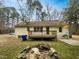 Backyard featuring wood deck, mature trees, firepit, and an old rock border at 1515 Indian Camp Rd, Chapel Hill, NC 27516
