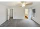 A spacious room offering neutral walls, gray carpet, and a ceiling fan providing ample lighting at 1515 Indian Camp Rd, Chapel Hill, NC 27516