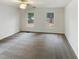 Bright carpeted bedroom with a ceiling fan and two windows providing natural light at 1515 Indian Camp Rd, Chapel Hill, NC 27516