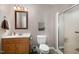 Bathroom with single sink vanity, toilet, and updated shower with glass doors at 161 Kerr Lake Club Dr, Henderson, NC 27537