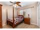 Cozy bedroom featuring patterned bedding, hardwood accents, and a light-filled window at 161 Kerr Lake Club Dr, Henderson, NC 27537