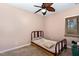 Simple bedroom featuring carpet, basic bed frame, and a window with natural light at 161 Kerr Lake Club Dr, Henderson, NC 27537