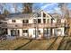 Stunning exterior view showcasing a large deck, expansive windows, and a sprawling backyard perfect for outdoor activities at 161 Kerr Lake Club Dr, Henderson, NC 27537