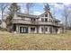 Impressive back exterior featuring a raised deck, well-maintained lawn, and abundant natural light at 161 Kerr Lake Club Dr, Henderson, NC 27537