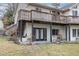 View of the home's exterior featuring a spacious deck and lower-level patio area at 161 Kerr Lake Club Dr, Henderson, NC 27537