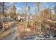 A home nestled amongst the trees features a large deck perfect for enjoying the natural surroundings at 161 Kerr Lake Club Dr, Henderson, NC 27537