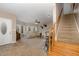 Bright open-concept living room showcasing a neutral palette, plush carpet, stairs and large windows for ample light at 161 Kerr Lake Club Dr, Henderson, NC 27537