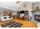 Open-concept living room featuring a fireplace, TV and lots of natural light at 161 Kerr Lake Club Dr, Henderson, NC 27537