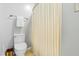 Bathroom featuring light colored walls, a toilet, and a curtained shower at 1709 Oak Tree Way, Raleigh, NC 27604