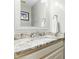 Bathroom vanity features granite countertop, decorative mirror, and neutral color scheme at 1709 Oak Tree Way, Raleigh, NC 27604