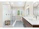 Bathroom featuring a frameless glass shower, double vanity, and modern fixtures at 1709 Oak Tree Way, Raleigh, NC 27604