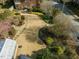 Aerial view of landscaped yard with lush greenery and winding stone walkway at 201 W Park Dr, Raleigh, NC 27605