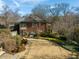 A two-story brick house with a well-kept lawn, stone walkway, and a cozy screened porch at 201 W Park Dr, Raleigh, NC 27605