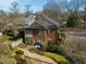 A well-maintained brick house with a screened porch and stone walkway at 201 W Park Dr, Raleigh, NC 27605