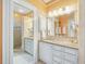 Bright bathroom featuring neutral-toned walls, large mirror and modern vanity at 201 W Park Dr, Raleigh, NC 27605