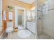 Bathroom featuring a glass-door shower, vanity with a marble countertop, and beige tile at 201 W Park Dr, Raleigh, NC 27605