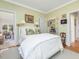 Bedroom with white coverlet, neutral walls, shuttered window, and wood flooring at 201 W Park Dr, Raleigh, NC 27605