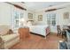 Bedroom with a bed, an armchair, carpeted floors, and a window with plantation shutters at 201 W Park Dr, Raleigh, NC 27605