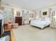 Spacious bedroom featuring an ornate bed frame, decorative curtains and a charming armchair at 201 W Park Dr, Raleigh, NC 27605