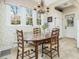 Bright breakfast nook with a charming table and chairs, chandelier, and view from multiple large windows at 201 W Park Dr, Raleigh, NC 27605