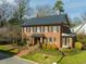 Charming two-story brick home with manicured front yard and mature landscaping at 201 W Park Dr, Raleigh, NC 27605