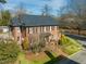 Beautiful brick home with a well-kept lawn, mature trees, and charming front walkway at 201 W Park Dr, Raleigh, NC 27605