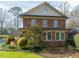 Exterior elevation of a two-story brick home with neutral trim and traditional windows at 201 W Park Dr, Raleigh, NC 27605