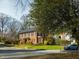 Brick two-story home with traditional architecture, well-maintained lawn, and mature landscaping at 201 W Park Dr, Raleigh, NC 27605