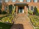 Inviting brick pathway with landscaped flower beds leading to the home's front entrance at 201 W Park Dr, Raleigh, NC 27605