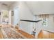 Hallway with wood floors, white trim, and access to bedrooms and staircase at 201 W Park Dr, Raleigh, NC 27605