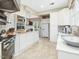This light and airy kitchen features white cabinetry, stainless appliances, and an open floor plan at 201 W Park Dr, Raleigh, NC 27605