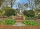 Beautiful brick steps lead up to the well-manicured backyard garden at 201 W Park Dr, Raleigh, NC 27605