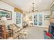 A spacious living room with a fireplace, large windows, and a cozy seating area at 201 W Park Dr, Raleigh, NC 27605