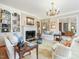 Elegant living room featuring built-in bookshelves, fireplace, and ample seating at 201 W Park Dr, Raleigh, NC 27605