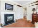 Living room with a fireplace, mantle, a dark rug, and hardwood floors at 201 W Park Dr, Raleigh, NC 27605