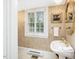 Classic powder room with pedestal sink, ornate mirror and window with shutter, exuding vintage charm at 201 W Park Dr, Raleigh, NC 27605