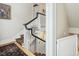 Elegant staircase with white railings and dark wood accents, showcasing classic design at 201 W Park Dr, Raleigh, NC 27605