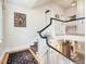 Hallway and staircase featuring wooden floors and white railing with black accents at 201 W Park Dr, Raleigh, NC 27605