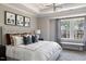 Bright bedroom with a large bed, a window with curtains and a bench seat at 2013 Trident Maple Ln, Chapel Hill, NC 27517